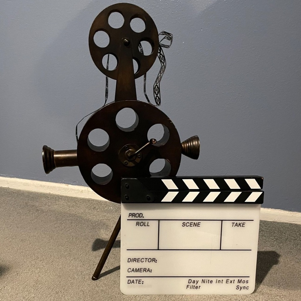 Metal cinema reel decor with movie clapper